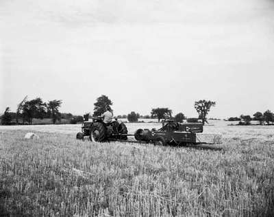 Baling using an IHC McCormick B250 tractor and an IHC McCormick 46 baler.