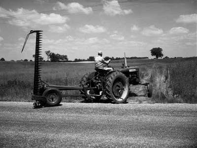 Mowing with an IHC McCormick Farmall 230 tractor and an pull behind mower.