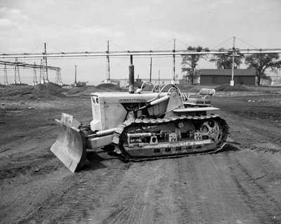 An IHC TD-5 crawler tractor wtih front mounted dozer blades ...