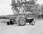 An IHC 350 tractor pulling an electric generator.