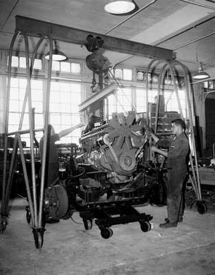 Lowering a Rolls Royce engine into a chasis.