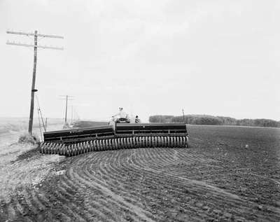 Planting seeds with IHC McCormick seed drills and an IHC 560 tractor on the Elder Farm, June 4-19, 1960, in Manitoba.