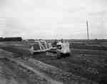 Road construction with  an IHC Crawler tractor and soil compacting rollers.