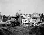 Marshall Contracting doing road repair using an IHC truck, model B180?, and IHC TD15 crawler tractor with a tractor mounted shovel, outside the IHC General Office in Stoney Creek, Ontario.