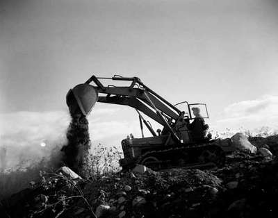 Clearing land with an IHC TD-5 crawler tractor and a tractor mounted loader.