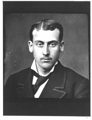 Portrait of a young man with a crooked tie.