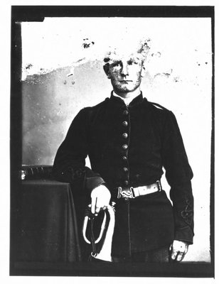 Portrait of a young man in military uniform, holding a bugle.