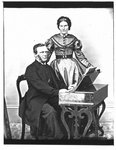 Portrait of a man and woman at a melodeon.