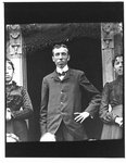 Portrait of a man and two women in a doorway.