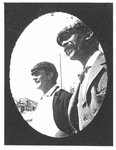 Street portrait of two smiling men in caps.