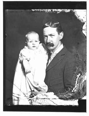 Portrait of John Connon as a young man, holding an infant.