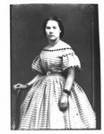 Portrait of a young woman in a checked dress.