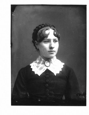 Portrait of a young woman with a white collar and cameo broach