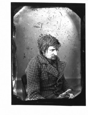 Portrait of an unidentified man in checked jacket.