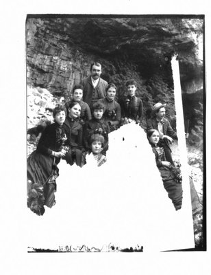 Portrait of a group of men and women on a rocky river bank.