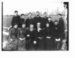 Portrait of an unidentified group, possibly a family, taken outdoors.