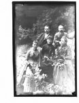 Group portrait, three women and two men, on a river bank.