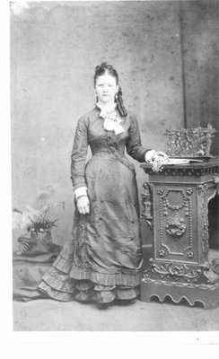 Full length portrait of an unidentified young woman.