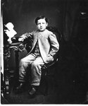 Portrait of a young boy, seated.