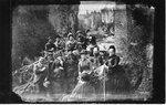 Group portrait of unidentified men and women, with river and Elora Gorge in the background.