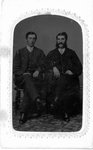 Full length portrait of two unidentified men, seated.