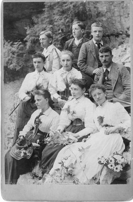 Outdoor portrait of young men and women against a rock background.