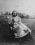 Outdoor portrait of an unidentified elderly lady, seated.