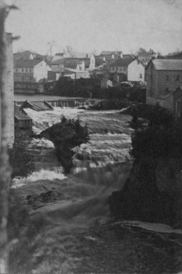 View of the Tooth of Time, Elora, with buildings in the background.