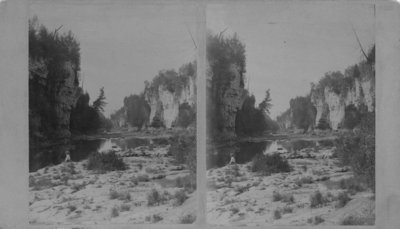 Elora Gorge and the river, with a person seated at the riverbank.