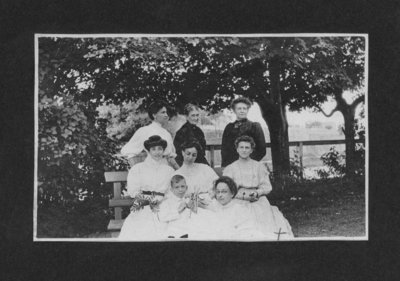 Group portrait of seven women and one young boy.