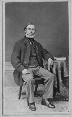 Full length portrait of Andrew Gordon, seated.