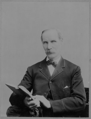 Thomas Connon, Sr., holding a book.