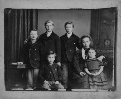 Group portrait of 6 children, 4 boys and 2 girls.