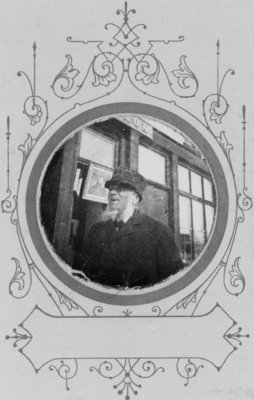 Portrait of an unidentified man with a white beard, taken in front of the Connon Studio, in Elora, Ontario.