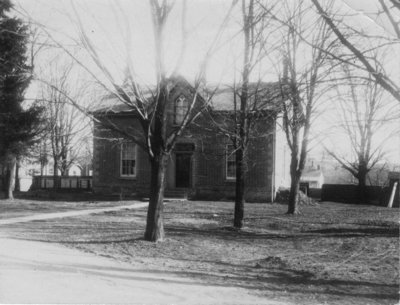 View of an "Ontario cottage" with gothic window in a gable above the centre front door