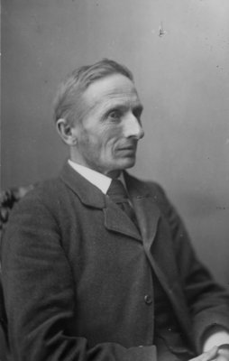 Portrait of an unidentified gentleman, seated, in a business suit.