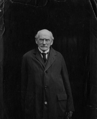 Portrait of an unidentified older gentleman wearing an overcoat.