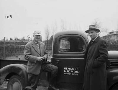 Two men next to truck, Hemlock Park Farms, Kingston ON