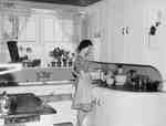 Unidentified Woman Standing in 1940's Kitchen