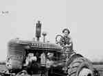 Unidentified Female Driving a Tractor