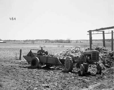 Unidentified Man Loading a Manure Spreader