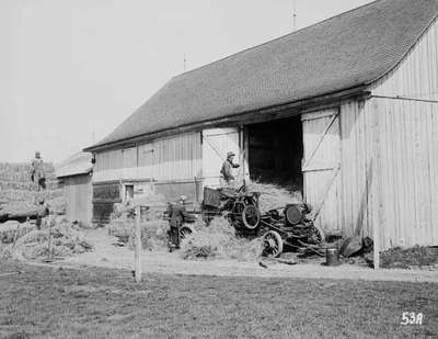 Unidentified Men Baling Hay