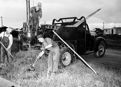 Three Unidentified Men Erecting Utility Poles