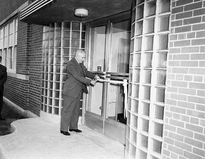 Man Cutting Ribbon at Branch Opening, Chatham, ON