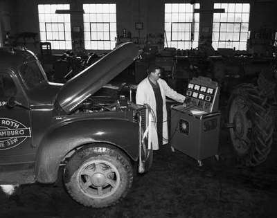 Unidentified Man Checking Truck Engine