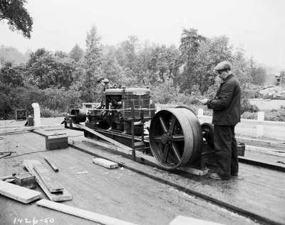 Men Next to a Gas Powered Engine on Work Site