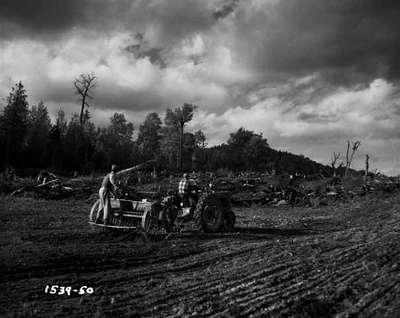 Men Sowing Seeds in a Field