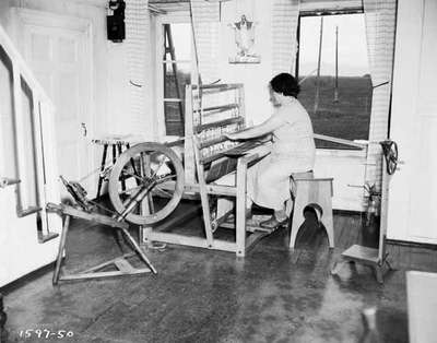 Woman Sitting at a Weaving Loom