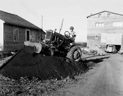 Tractor with Dozer Blades Moving Dirt