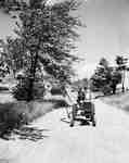 Unidentified Man Driving Down Dirt Road on a Tractor, Waterdown, ON